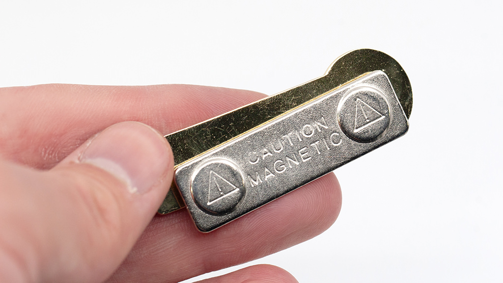 Rear profile view of magnetic badge attachment showing caution magnetic clasp mechanism for school name badges